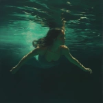 **Swimmer gliding just below the surface, long hair flowing, muted moonstone emerald and sand-colored light with subtle golden caustics, peaceful and quiet." --profile fbik8zy --v 7.0** - Upscaled by <@997706764311089183> (fast)
