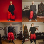 **A young handsome tan skinned white man with dirty blonde wavy short hair dressed in a Y2K Cholo gangster style, wearing a black long sleeve Dickies work shirt and extremely baggy, extra-long, 3XL plain long red and black Nike basketball shorts. His shorts are very long and go down to his ankles and feet. He is wearing Nike Cortez shoes in his house by a Christmas tree** - <@1061360796438900746> (fast)