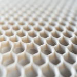 **Close-up of ceramic honeycomb catalyst substrate used in bioenergy emission control, shown in angled side view, perfect lighting on textured grid pattern, isolated studio scene, hyper-realistic and clean --ar 3:2 --v 6.1 --quality 2 --raw** - Upscaled (Creative) by <@1145244586088861708> (relaxed)