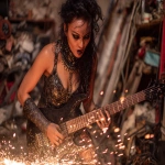 **heavy metal femme glamrock reptilian 80s hair bandsaw sawing through electric guitars, sparks and debris flying everywhereas the band plays down with the thickness --p djcuvnt ht8lvr3 --ar 4:3** - Image #1 <@948741381743083580>