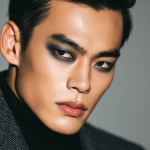 **full-face portrait of a fashionable 30-year-old Taiwanese man, long-shaped face, fair pale skin, thick eyebrows, large expressive double-lidded eyes, and naturally full lips, with softly contoured cheeks not sunken; styled with bold high-fashion smokey eye makeup in deep gray and black tones, paired with glossy lip color for a striking contrast; contemporary hairstyle with clean lines, cinematic editorial lighting highlighting makeup and hair details, blurred neutral background, sharp focus on facial features, refined fashion magazine aesthetic, no text, no watermark --ar 1:1** - Image #4 <@1090872516857299025>