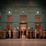 **A cinematic still, a film by Wes Anderson, a bustling british police station, wide shot, --v 7.0 --ar 16:9** - Image #1 <@1105536971348123781>