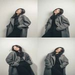 **A Korean woman smile with long hair, wearing an oversized gray woolen coat and black pants. The photography style features white tones, minimalist design, and an elegant posture against a white background. Soft light shines on her face, highlighting its delicate features. --ar 9:16 --v 7.0** - Variations (Strong) by <@1136547221920296960> (fast)