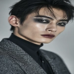 **full-face portrait of a fashionable 30-year-old Taiwanese man, long-shaped face, fair pale skin, thick eyebrows, large expressive double-lidded eyes, and naturally full lips, with softly contoured cheeks not sunken; styled with bold high-fashion smokey eye makeup in deep gray and black tones, paired with glossy lip color for a striking contrast; contemporary hairstyle with clean lines, cinematic editorial lighting highlighting makeup and hair details, blurred neutral background, sharp focus on facial features, refined fashion magazine aesthetic, no text, no watermark --ar 9:16** - Image #4 <@1090872516857299025>